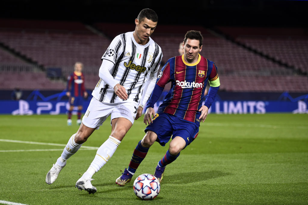 Cristiano Ronaldo (L) of Juventus FC is challenged by Lionel